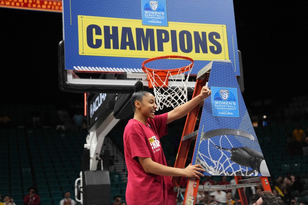 Mar 10, 2024; Las Vegas, NV, USA; Southern California Trojans guard JuJu Watkins (12) cuts the net after the Pac-12 Tournament women's championship game against the Stanford Cardinal at MGM Grand Garden Arena.