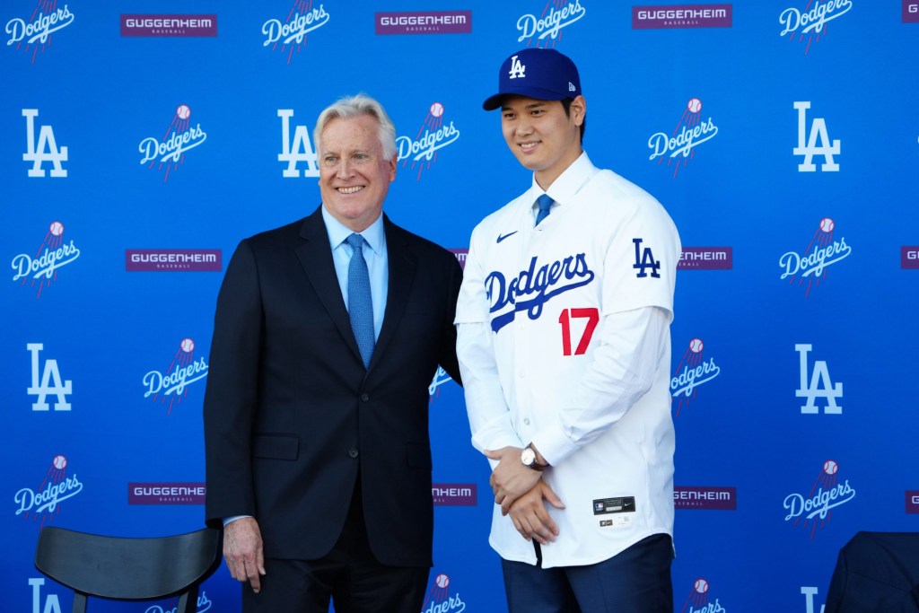 Shohei Ohtani is the highest paid MLB player right now. Dec 14, 2023; Los Angeles, CA, USA; Los Angeles Dodgers designated hitter Shohei Ohtani (17) poses with owner Mark Walter at press conference at Dodger Stadium. Mandatory Credit: Kirby Lee-USA TODAY Sports