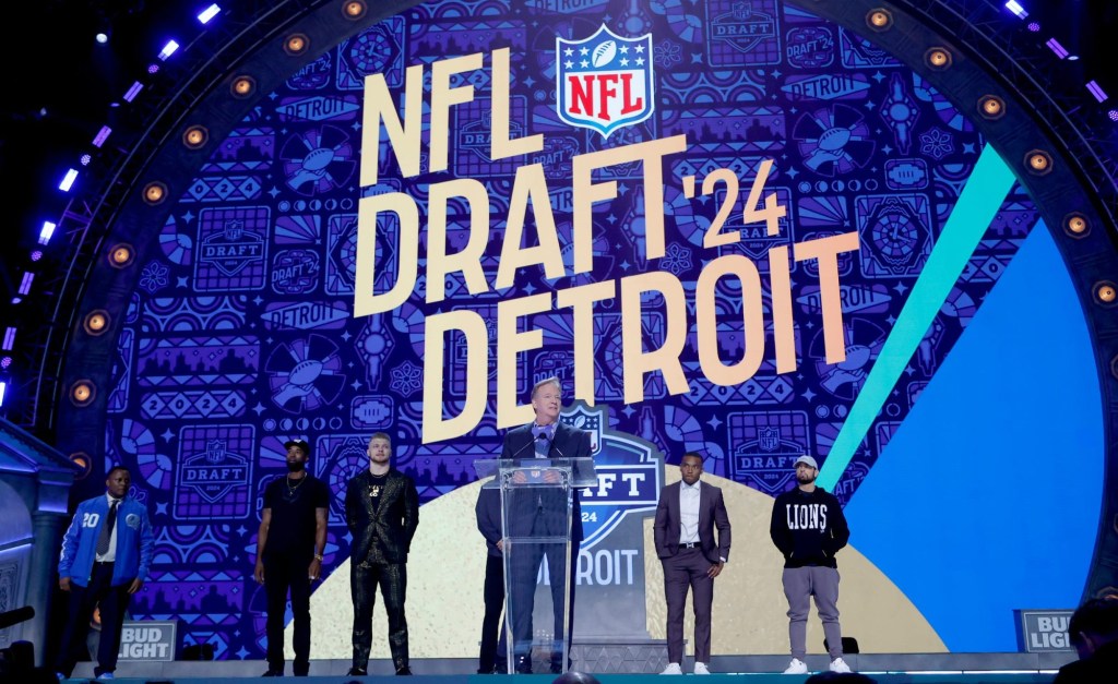NFL commissioner Roger Goodell addresses the crowd with Eminem and Detroit Lions Jared Goff, Amon-Ra St. Brown and Aidan Hutchinson and Hall of Famers Calvin Johnson and Barry Sanders on the stage before Round 1 of the NFL draft on April 25, 2024.