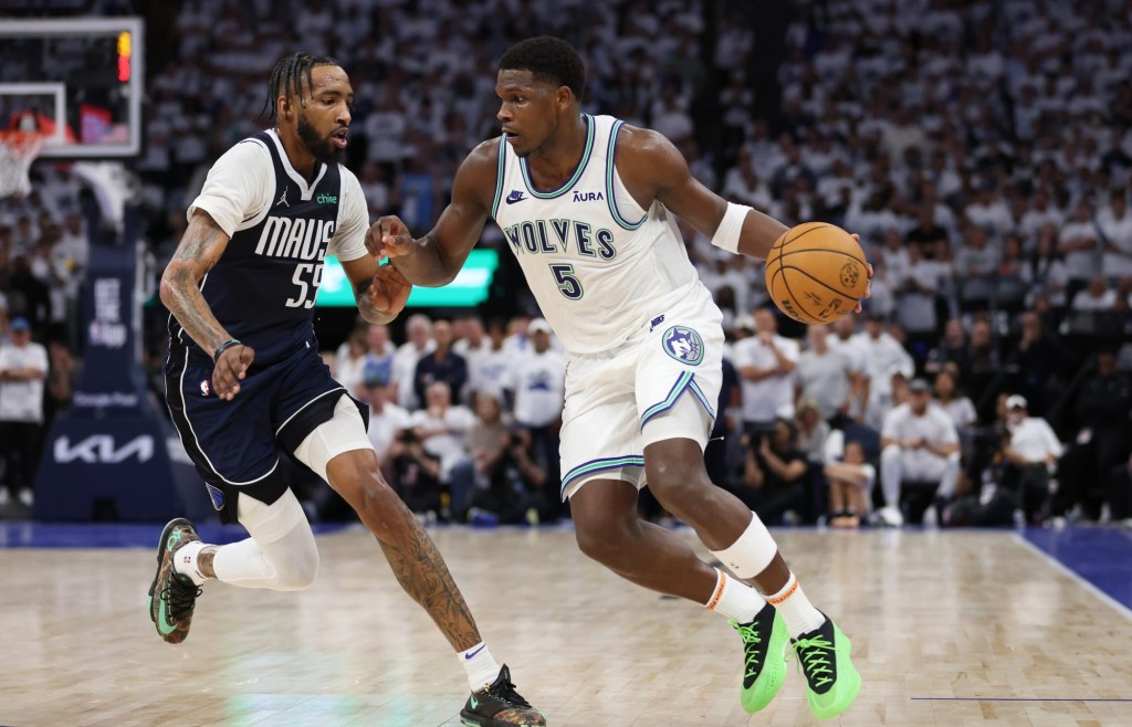 May 22, 2024; Minneapolis, Minnesota, USA; Minnesota Timberwolves guard Anthony Edwards (5) controls the ball against Dallas Mavericks forward Derrick Jones Jr. (55) in the fourth quarter during game one of the western conference finals for the 2024 NBA playoffs at Target Center.