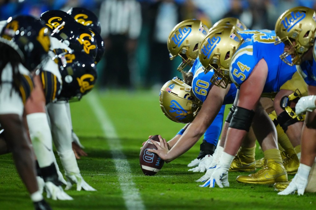 Nov 25, 2023; Pasadena, California, USA; Helmets at the line of scrimmage as UCLA Bruins long snapper Beau Gardner (60) snaps the ball against the California Golden Bears at the Rose Bowl.