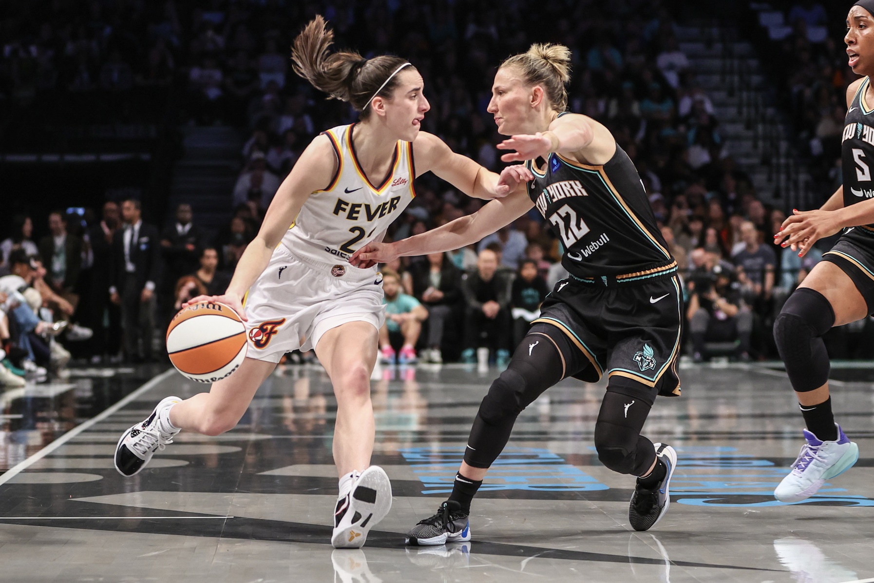 May 18, 2024; Brooklyn, New York, USA; Indiana Fever guard Caitlin Clark (22) looks to drive past New York Liberty guard Courtney Vandersloot (22) in the first quarter at Barclays Center. Mandatory Credit: Wendell Cruz-USA TODAY Sports