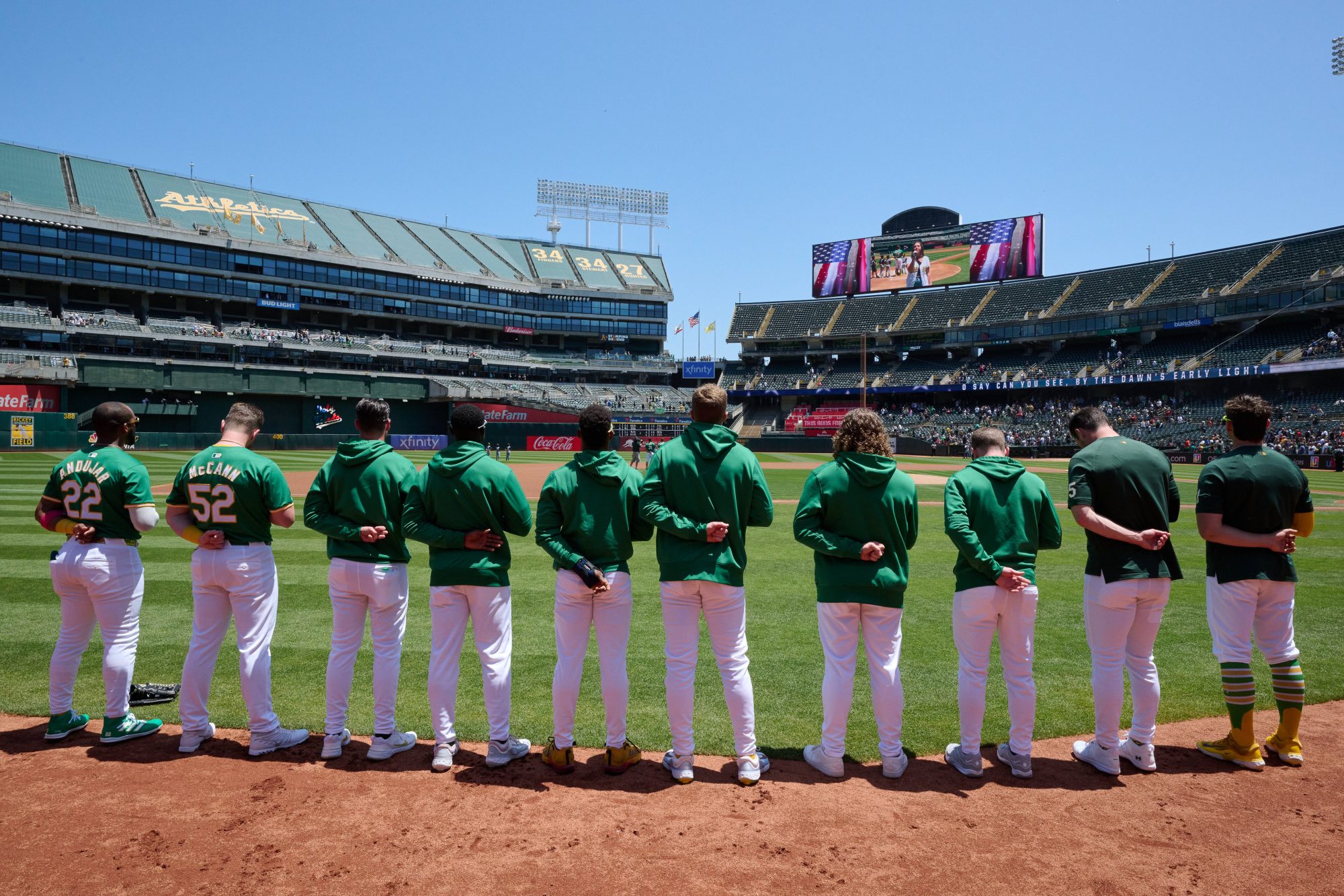 May 26, 2024; Oakland, California, USA; Oakland Athletics players stand during the national anthem before the game against the Houston Astros at Oakland-Alameda County Coliseum.