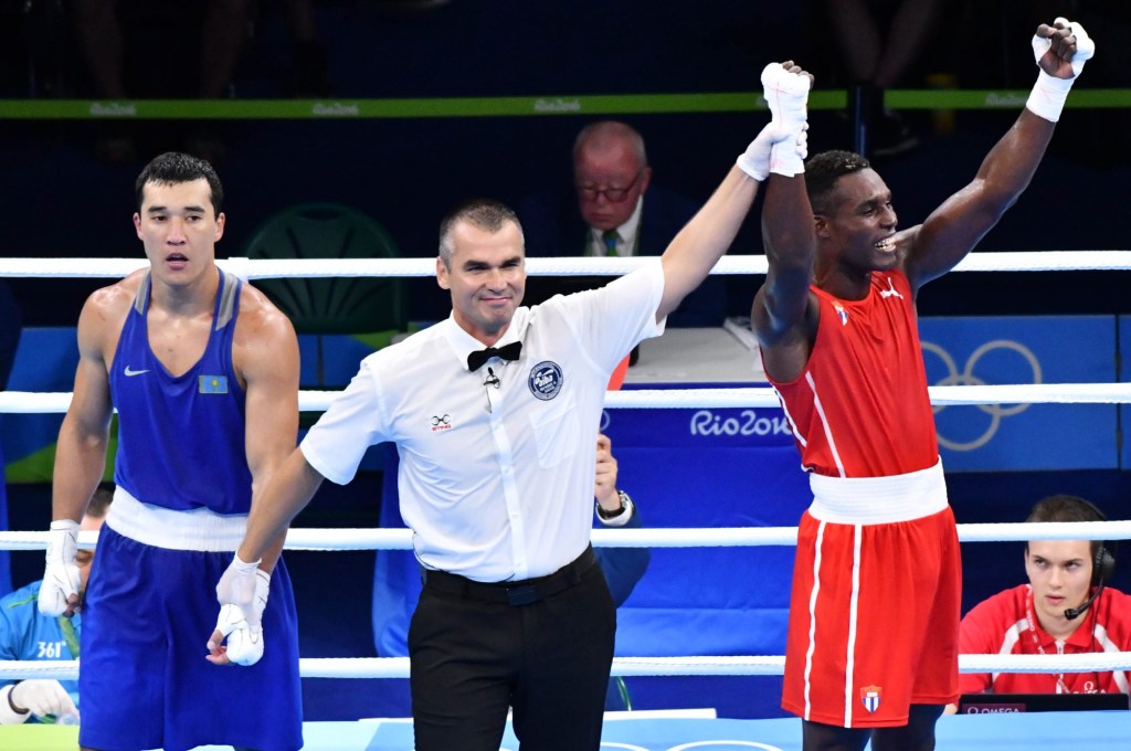Aug 18, 2016; Rio de Janeiro, Brazil; Julio Cesar La Cruz (CUB, red) faces Adilbek Niyazymbetov (KAZ, blue) during boxing final in the Rio 2016 Summer Olympic Games at Riocentro - Pavilion