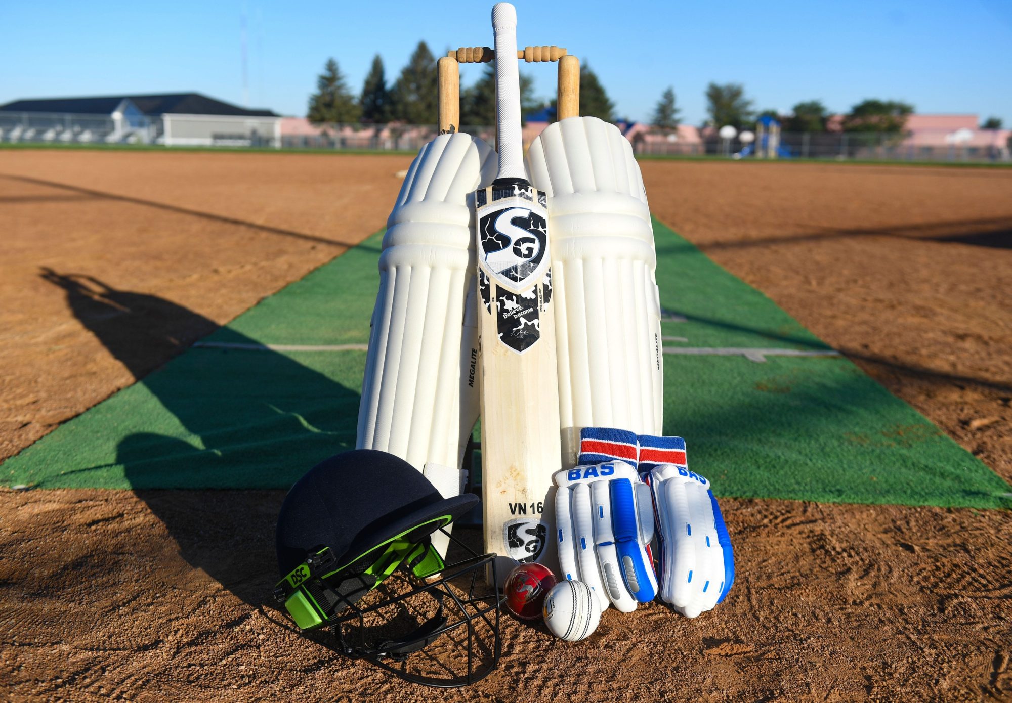 Example of professional cricket equipment, including leg pads, a bat, a helmet, gloves and balls, are set up on Sunday, September 11, 2022, at Kenny Anderson Park in Sioux Falls.