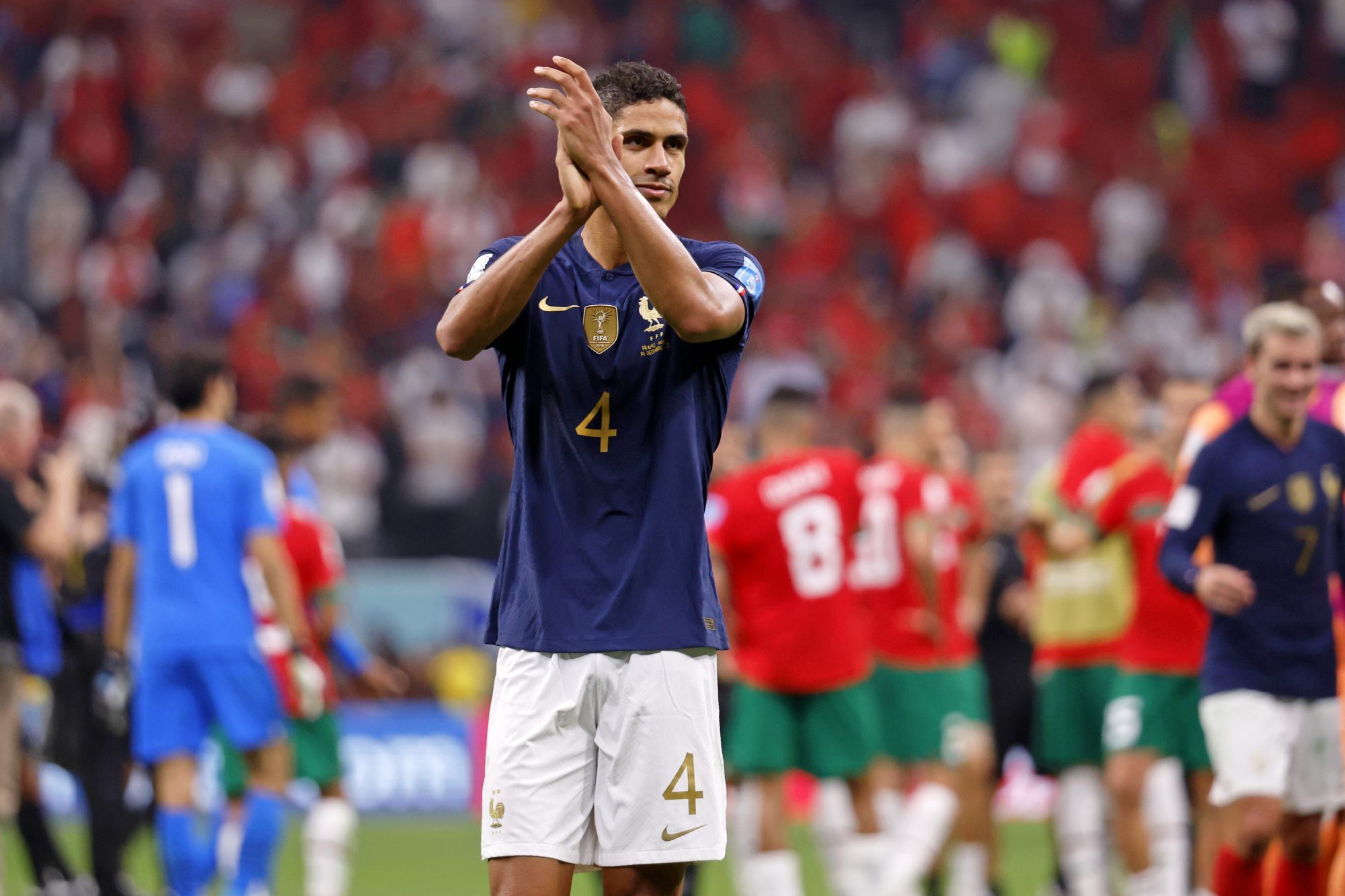 Dec 14, 2022; Al Khor, Qatar; France defender Raphael Varane (4) acknowledges fans after winning a semifinal match against Morocco during the 2022 World Cup at Al Bayt Stadium. Mandatory Credit: Yukihito Taguchi-USA TODAY Sports