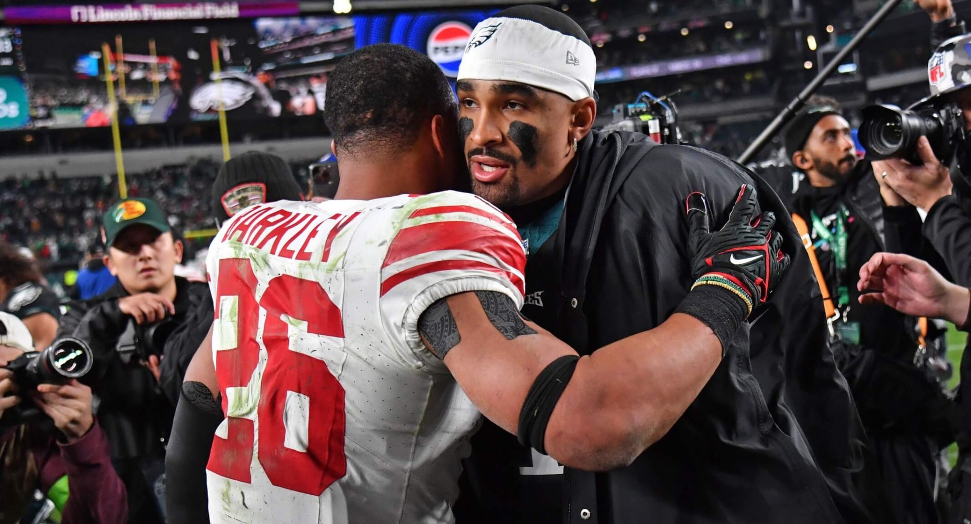 Dec 25, 2023; Philadelphia, Pennsylvania, USA; Philadelphia Eagles quarterback Jalen Hurts (1) and New York Giants running back Saquon Barkley (26) at Lincoln Financial Field. Mandatory Credit: Eric Hartline-USA TODAY Sports