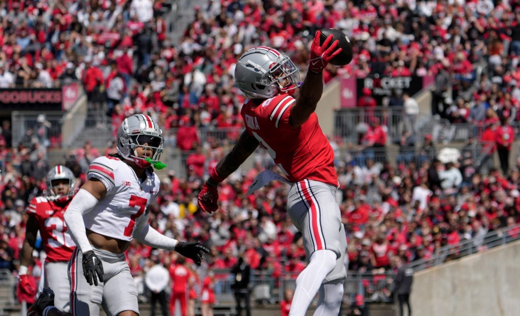 April 13, 2024; Columbus, Ohio, USA; Ohio State Buckeyes wide receiver Emeka Egbuka (2) catches a pass for the scarlet team while defended by cornerback Jordan Hancock (7) of the grey team during the first half of the LifeSports Spring Game at Ohio Stadium on Saturday.