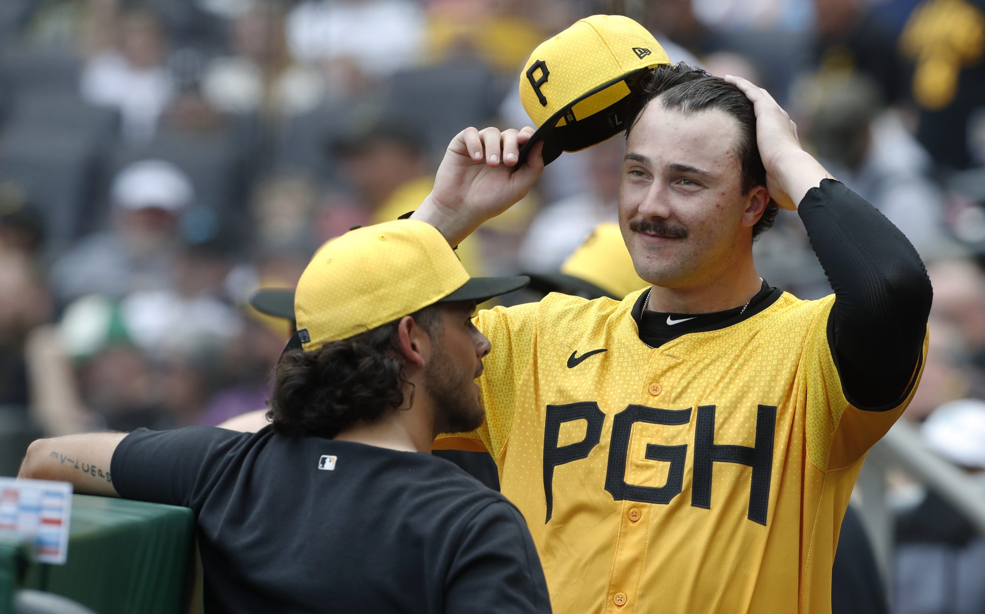 Jun 23, 2024; Pittsburgh, Pennsylvania, USA; Pittsburgh Pirates starting pitcher Paul Skenes (right) reacts as he talks with pitcher Jared Jones (left) after the seventh inning against the Tampa Bay Rays at PNC Park.