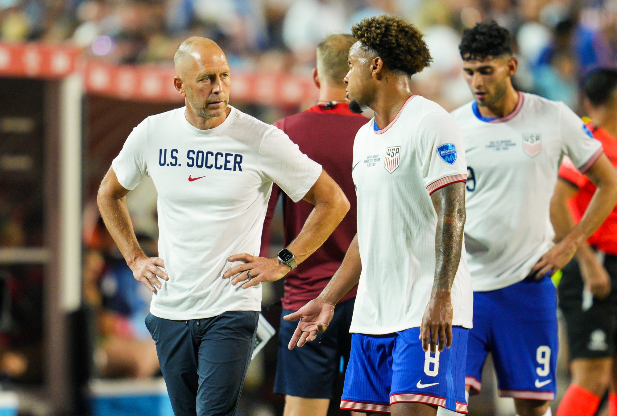 Jul 1, 2024; Kansas City, Missouri, USA; United States head coach Gregg Berhalter talks with midfielder Weston McKennie (8) during the second half of a Copa America match against Uruguay at Arrowhead Stadium.