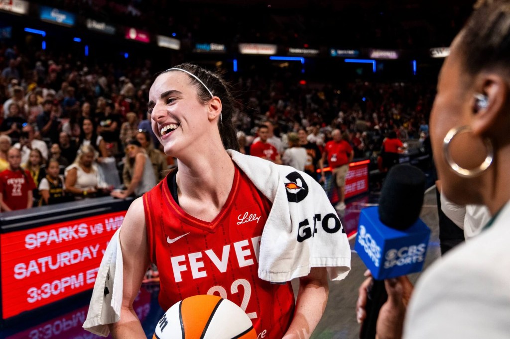 Jul 6, 2024; Indianapolis, Indiana, USA; Indiana Fever guard Caitlin Clark (22) smiles in an interview after becoming the first rookie to have a triple-double during a game against the New York Liberty at Gainbridge Fieldhouse. Mandatory Credit: Grace Smith/INDIANAPOLIS STAR-USA TODAY Sports