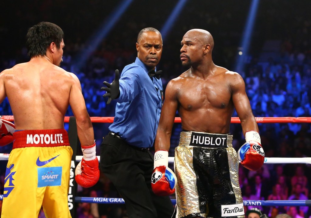 May 2, 2015; Las Vegas, NV, USA; Referee Kenny Bayless (center) separates Manny Pacquiao (left) from Floyd Mayweather during their boxing bout at the MGM Grand Garden Arena. Mandatory Credit: Mark J. Rebilas-USA TODAY Sports