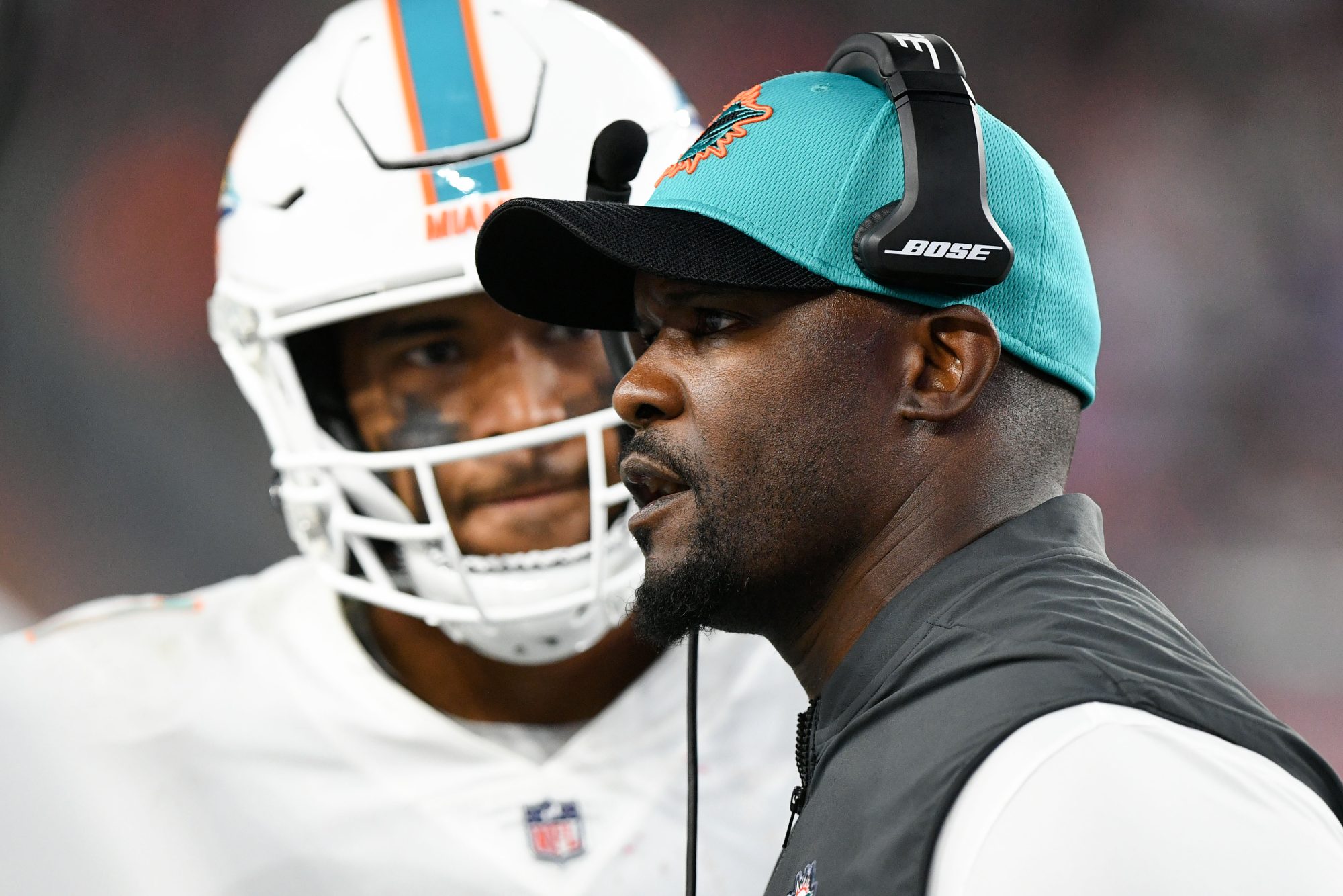 Sep 12, 2021; Foxborough, Massachusetts, USA; Miami Dolphins head coach Brian Flores talks with quarterback Tua Tagovailoa (1) during a timeout during the second half of a game against the New England Patriots at Gillette Stadium.