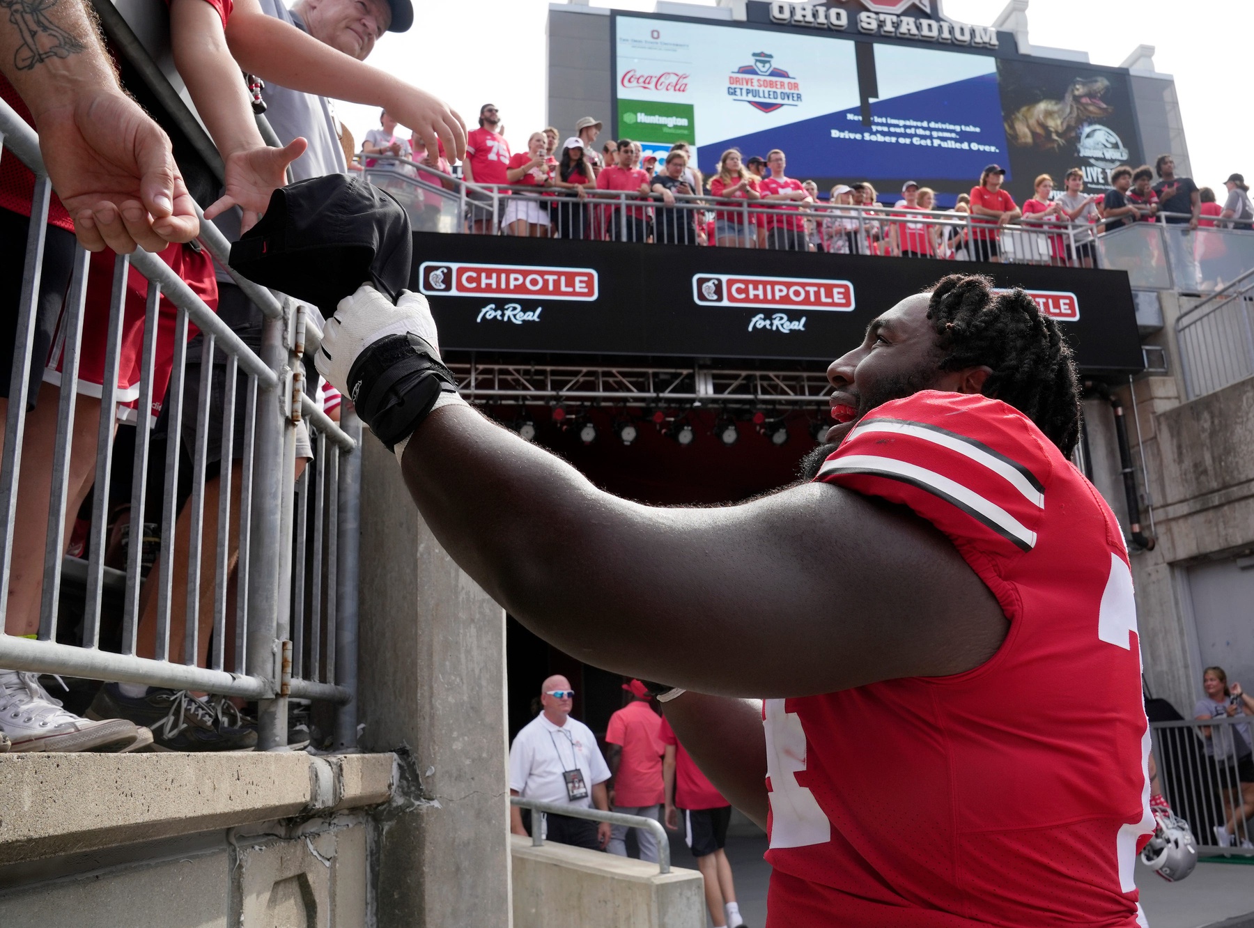 Ohio State Buckeyes offensive lineman Donovan Jackson (74) greets fans following Saturday's game against the Arkansas State Red Wolves at Ohio Stadium