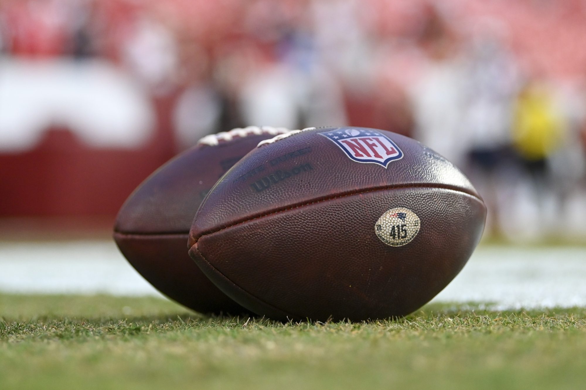 Aug 25, 2024; Landover, Maryland, USA; A detailed view of New England Patriots footballs on the field before the game against the Washington Commanders at Commanders Field.