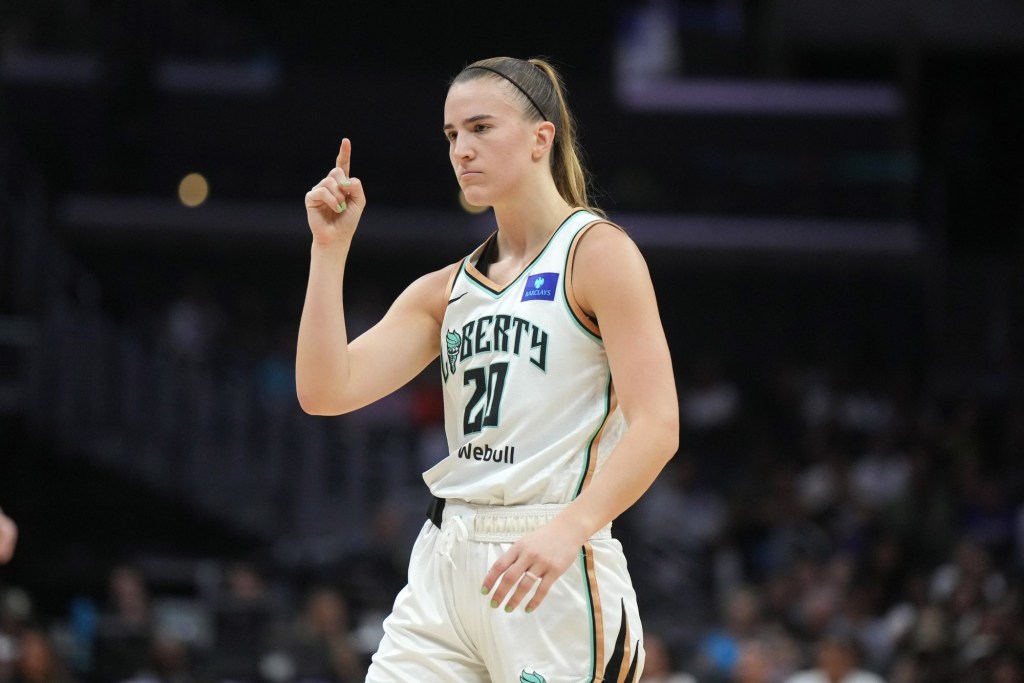 Aug 28, 2024; Los Angeles, California, USA; New York Liberty guard Sabrina Ionescu (20) gestures against the LA Sparks in the first half at Crypto.com Arena.