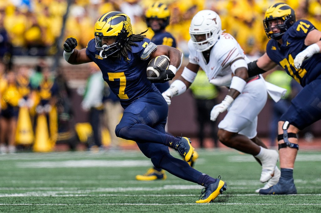 Michigan running back Donovan Edwards (7) runs for a first down against Texas during the first half at Michigan Stadium in Ann Arbor on Saturday, September 7, 2024.