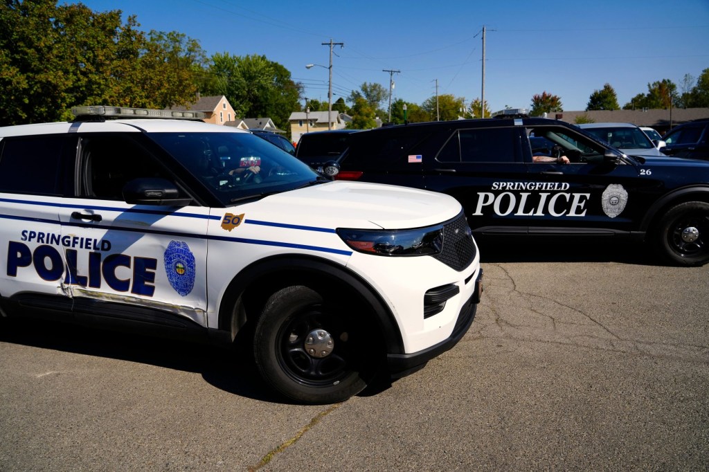 Springfield, Ohio police monitor the parking lot at the Premier English Evangelical Haitian Springfield, Ohio church