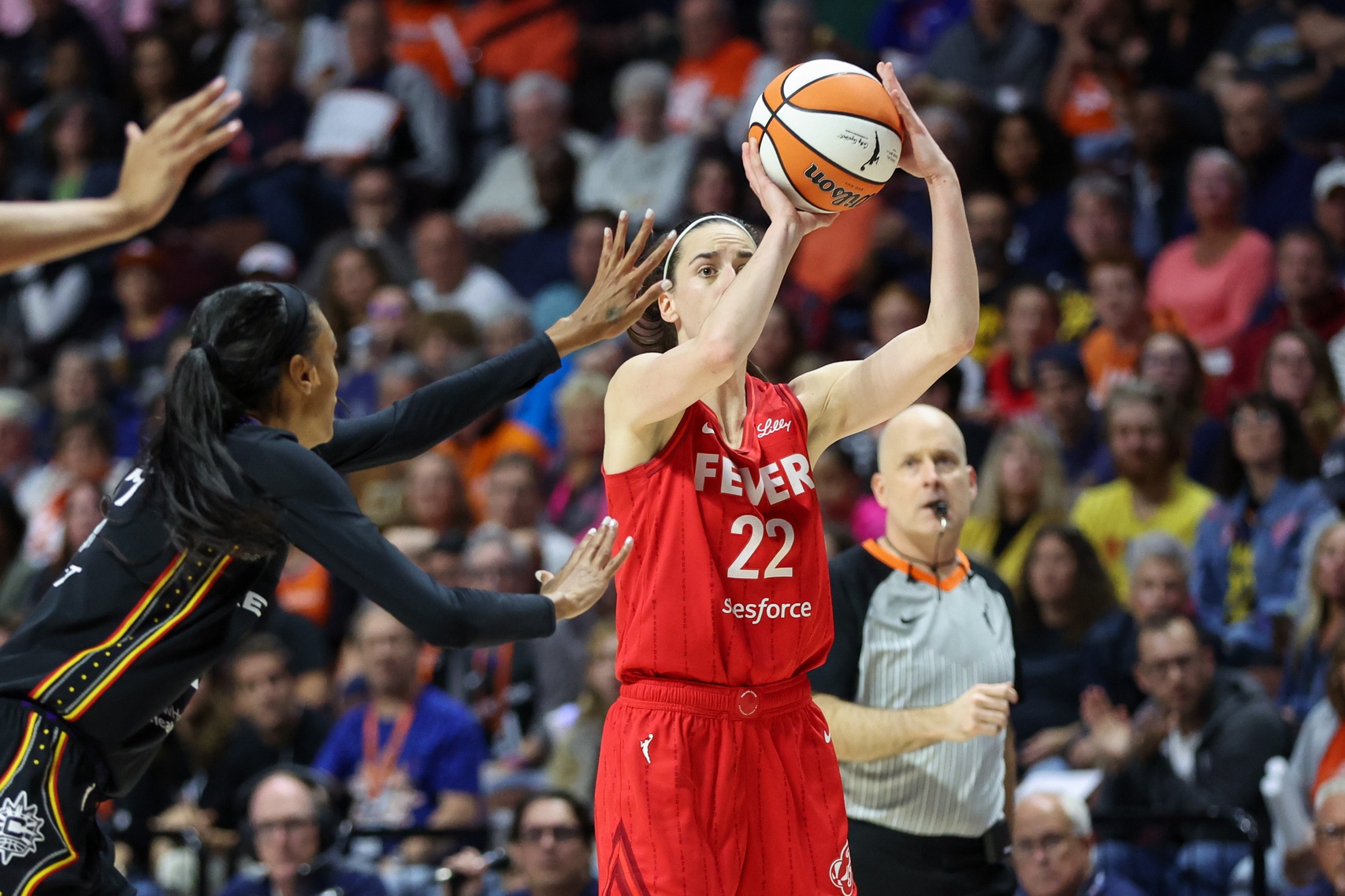 Sep 25, 2024; Uncasville, Connecticut, USA; Indiana Fever guard Caitlin Clark (22) shoots during the first half against the Connecticut Sun during game two of the first round of the 2024 WNBA Playoffs at Mohegan Sun Arena.