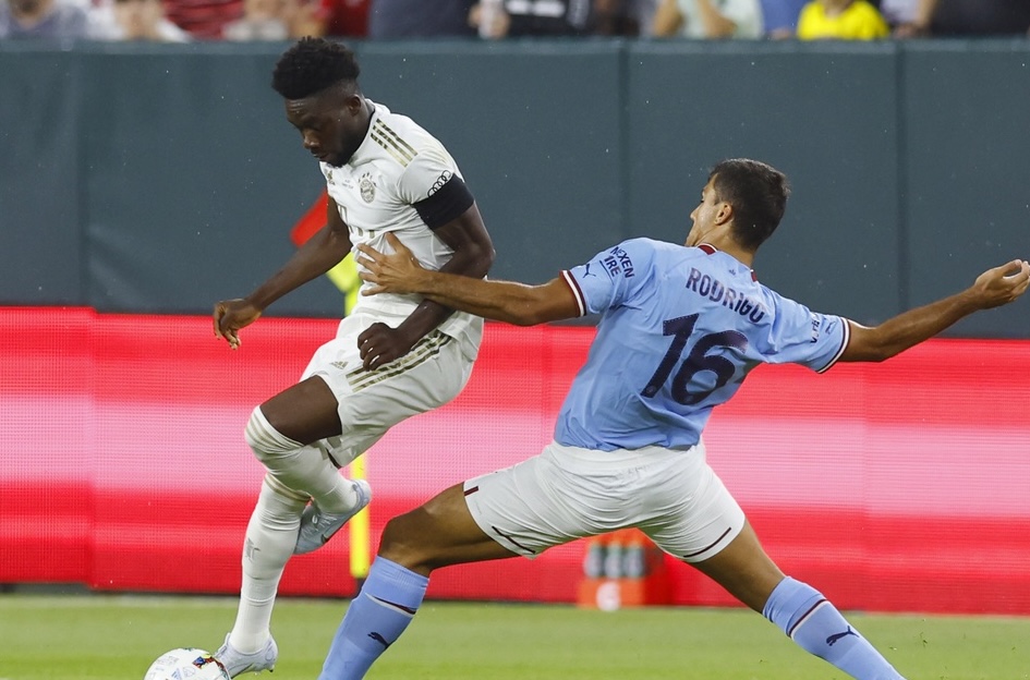 Man City midfielder Rodri (right) on a soccer pitch