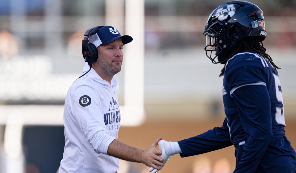 Utah State's football coach and a players.