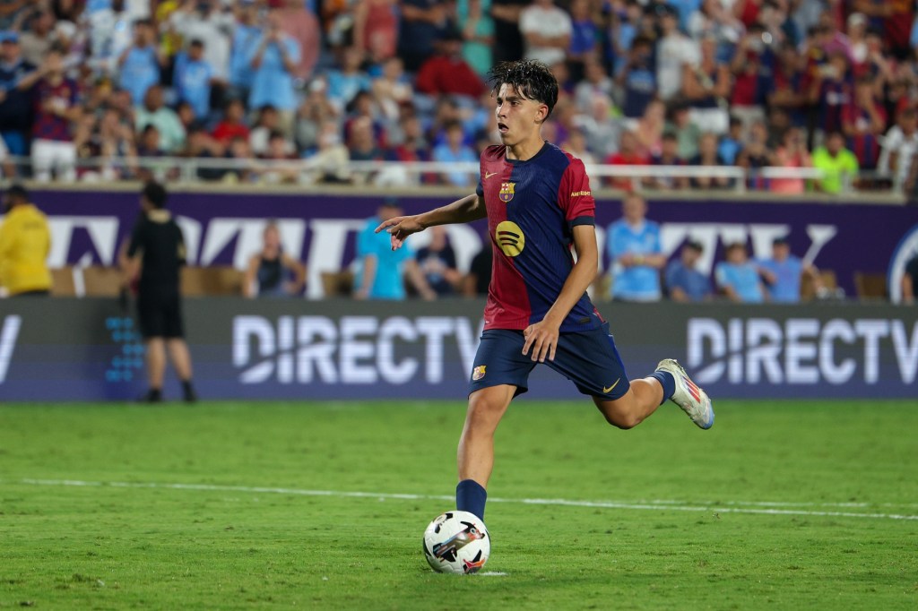 Jul 30, 2024; Orlando, FL, USA; Barcelona forward Lamine Yamal (27) makes a penalty kick against Manchester City in a tie breaker during a Champions Tour friendly match at Camping World Stadium