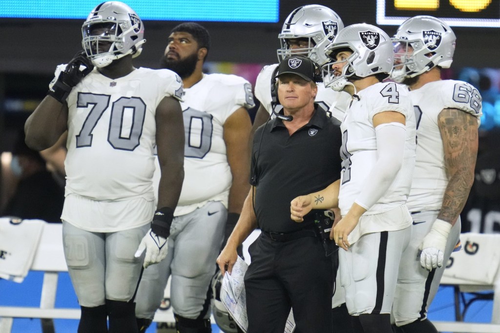 Oct 4, 2021; Inglewood, California, USA; Las Vegas Raiders head coach Jon Gruden talks with quarterback Derek Carr (4) during the second half against the Los Angeles Chargers at SoFi Stadium.