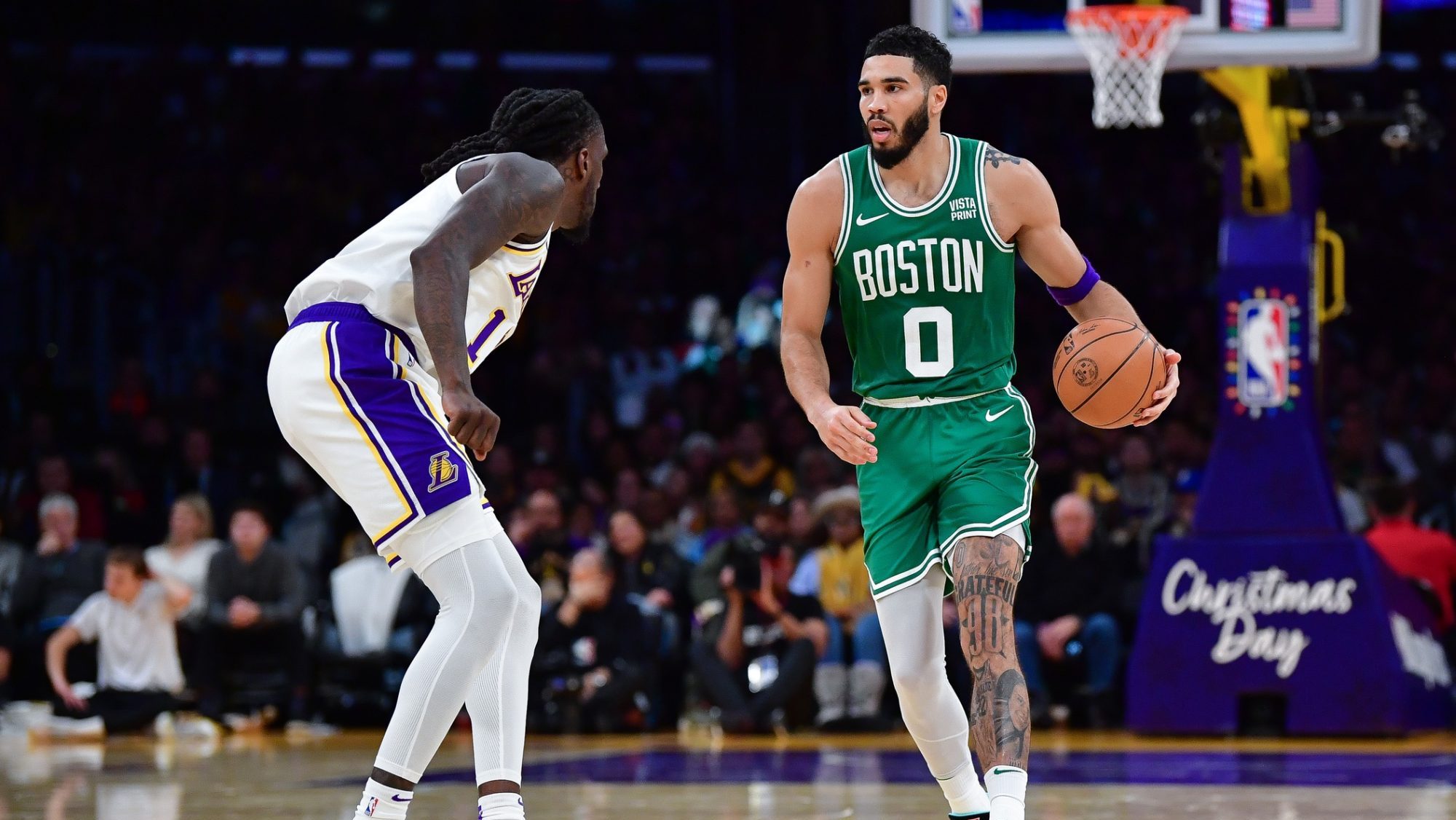 Dec 25, 2023; Los Angeles, California, USA; Boston Celtics forward Jayson Tatum (0) controls the ball against Los Angeles Lakers forward Taurean Prince (12) during the second half at Crypto.com Arena.