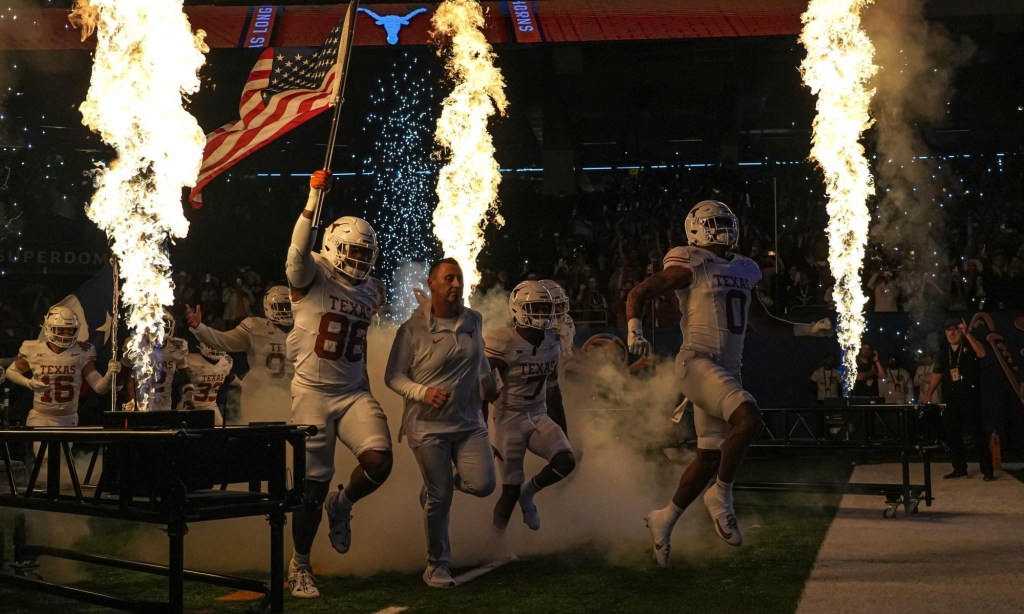 Texas Longhorns head coach Steve Sarkisian leads his team onto the field for the Sugar Bowl College Football Playoff semifinals game against the Washington Huskies at the Caesars Superdome on Monday, Jan. 1, 2024 in New Orleans, Louisiana.