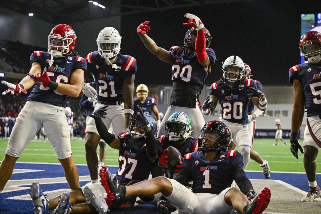 Feb 1, 2024; Frisco, TX, USA; West cornerback Jarius Monroe of Tulane (32) celebrates with his teammates in the end zone after Monroe intercepts a pass during the second half against the East at the Ford Center at The Star.