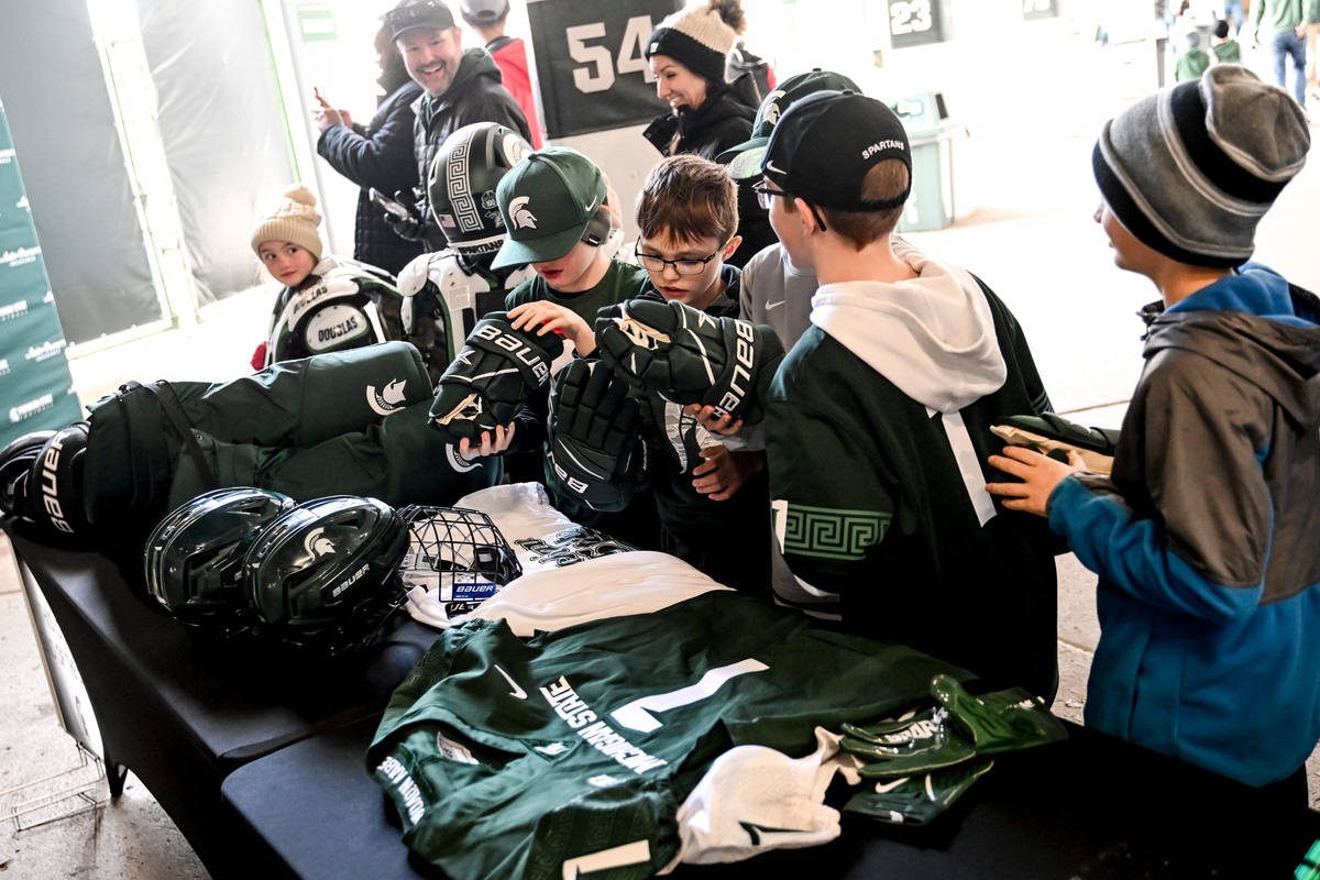 Young fans look over Michigan State sports equipment on display during the Spring Showcase on Saturday, April 20, 2024, at Spartan Stadium in East Lansing.