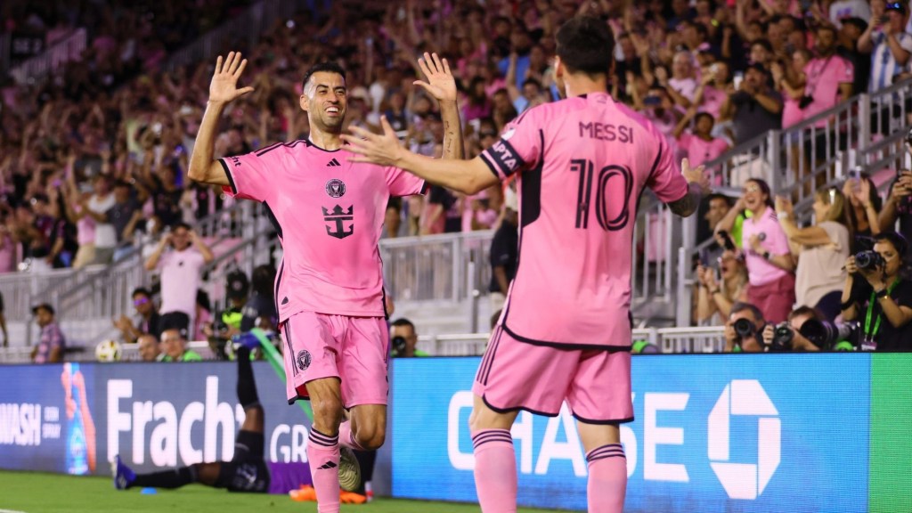 Apr 20, 2024; Fort Lauderdale, Florida, USA; Inter Miami CF defender Sergio Busquets (5) celebrates with forward Lionel Messi (10) after scoring a goal against Nashville SC in the first half at Chase Stadium.