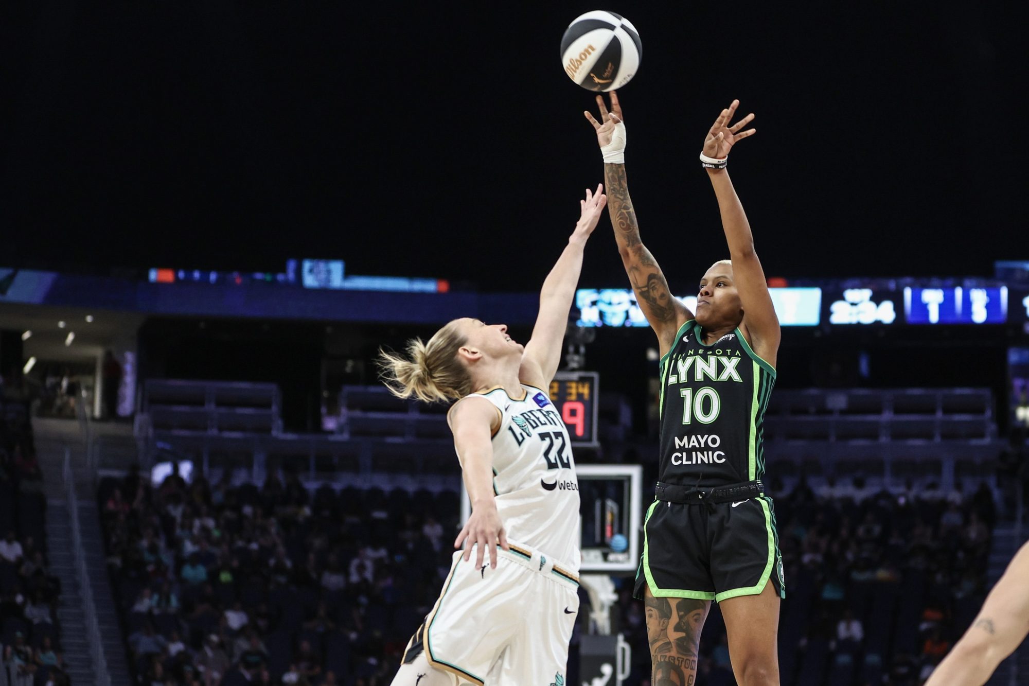 Jun 25, 2024; Belmont Park, New York, USA; Minnesota Lynx guard Courtney Williams (10) shoots over New York Liberty guard Courtney Vandersloot (22) in the first quarter of the Commissioner’s Cup Championship game at UBS Arena.