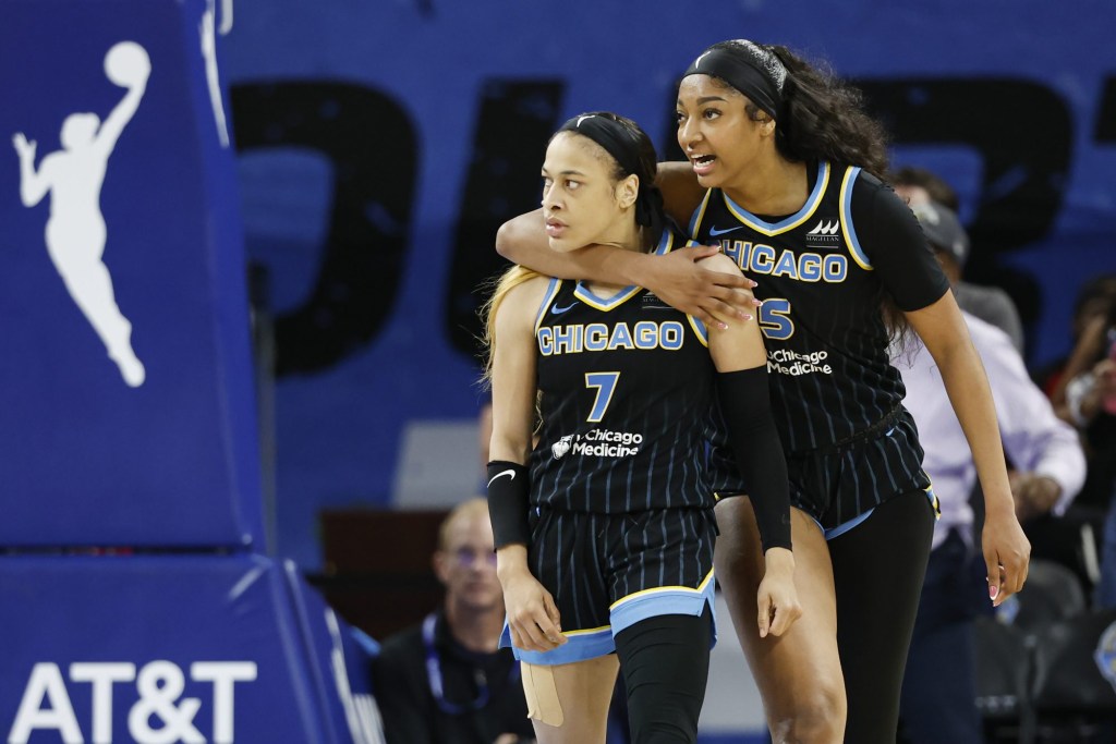 Aug 25, 2024; Chicago, Illinois, USA; Chicago Sky guard Chennedy Carter (7) reacts next to forward Angel Reese (5) after scoring against the Las Vegas Aces during the second half at Wintrust Arena.