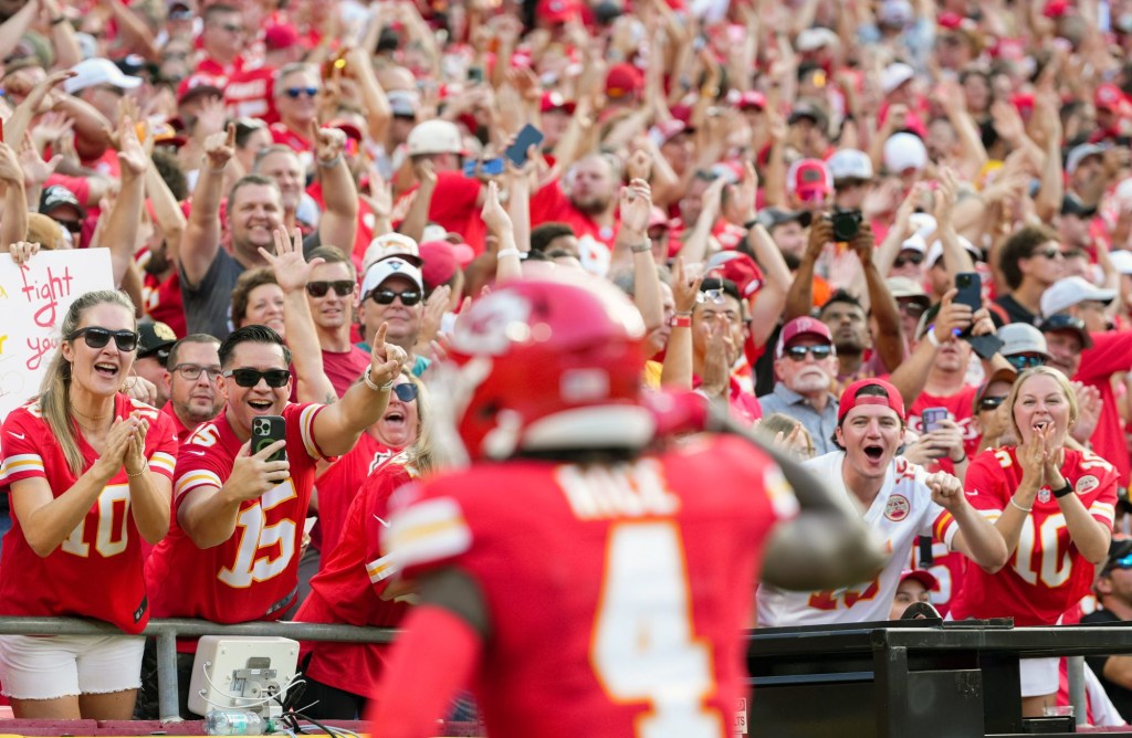 Sep 15, 2024; Kansas City, Missouri, USA; Kansas City Chiefs fans celebrate after a touchdown by Kansas City Chiefs wide receiver Rashee Rice (4) during the first half against the Cincinnati Bengals at GEHA Field at Arrowhead Stadium.