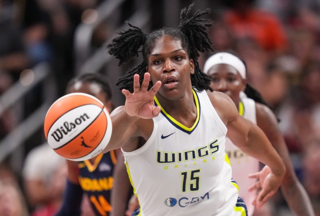 Dallas Wings center Teaira McCowan (15) reaches for the ball Sunday, Sept. 15, 2024, during the game at Gainbridge Fieldhouse in Indianapolis. The Indiana Fever defeated the Dallas Wings, 110-109.