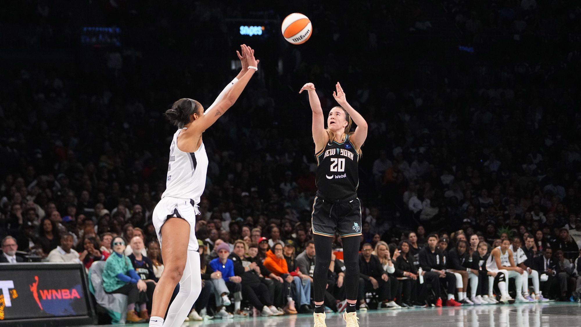 Sep 29, 2024; Brooklyn, New York, USA; New York Liberty guard Sabrina Ionescu (20) shoots a three point jump shot over Las Vegas Aces center A'ja Wilson (22) during game one of the 2024 WNBA Semi-finals at Barclays Center.