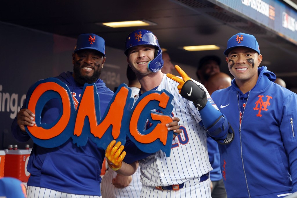 Oct 8, 2024; New York City, New York, USA; New York Mets first baseman Pete Alonso (20) celebrates in the dugout after hitting a solo home run with New York Mets pitcher Luis Severino (left) and pitcher Jose Quintana (right) in the second inning against the Philadelphia Phillies during game three of the NLDS for the 2024 MLB Playoffs at Citi Field.