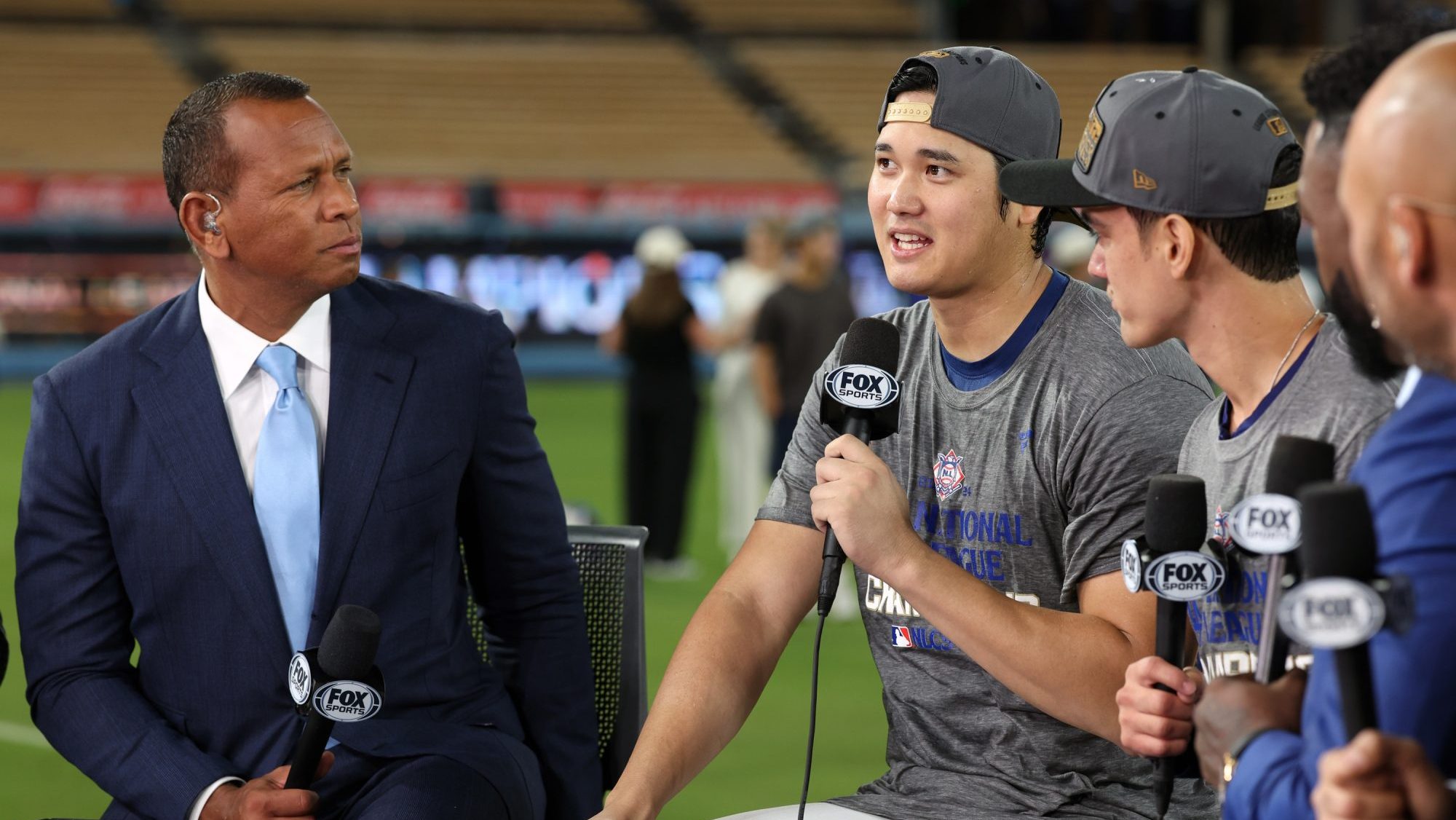 Oct 20, 2024; Los Angeles, California, USA; Fox Sports broadcasters David Ortiz and Alex Rodriguez talk with Los Angeles Dodgers designated hitter Shohei Ohtani (17) and his interpreter Will Ireton after the Los Angeles Dodgers defeated the New York Mets in game six of the NLCS to advance to the World Series in the 2024 MLB playoffs at Dodger Stadium.