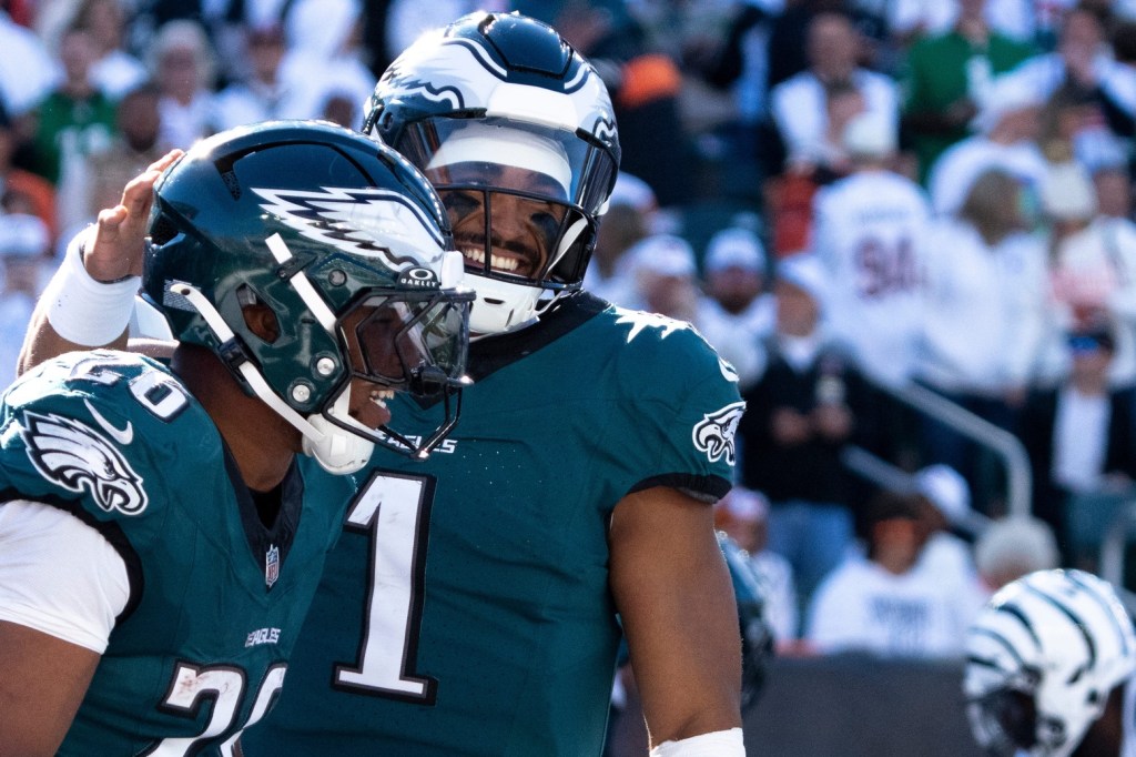 Philadelphia Eagles quarterback Jalen Hurts (1) reacts to scoring a touchdown with Philadelphia Eagles running back Saquon Barkley (26) in the fourth quarter of the NFL game against the Cincinnati Bengals at Paycor Stadium in Cincinnati on Sunday, Oct. 27, 2024.