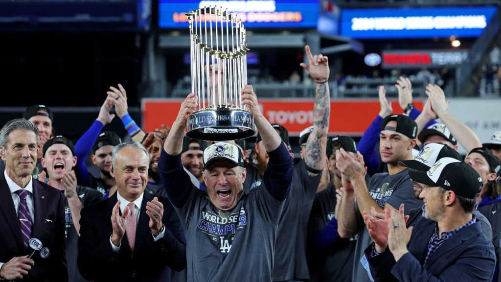 Oct 31, 2024; New York, New York, USA; Los Angeles Dodgers president and CEO Stan Kasten celebrates with the Commissioner’s Trophy after the Los Angeles Dodgers beat the New York Yankees in game four to win the 2024 MLB World Series at Yankee Stadium.