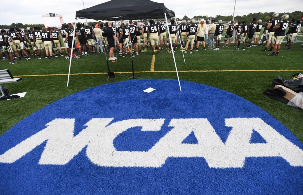 The NCAA logo on a football field