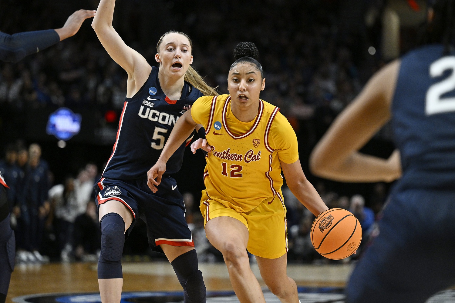 Apr 1, 2024; Portland, OR, USA; USC Trojans guard JuJu Watkins (12) drives to the basket during the second half against UConn Huskies guard Paige Bueckers (5) in the finals of the Portland Regional of the NCAA Tournament at the Moda Center.