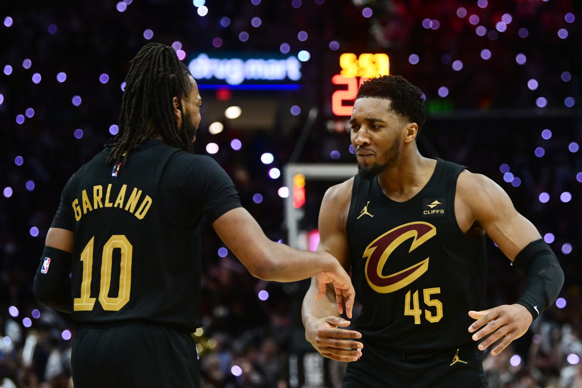 May 5, 2024; Cleveland, Ohio, USA; Cleveland Cavaliers guard Donovan Mitchell (45) celebrates with guard Darius Garland (10) after Garland hit a three point basket during the second half against the Orlando Magic in game seven of the first round for the 2024 NBA playoffs at Rocket Mortgage FieldHouse.