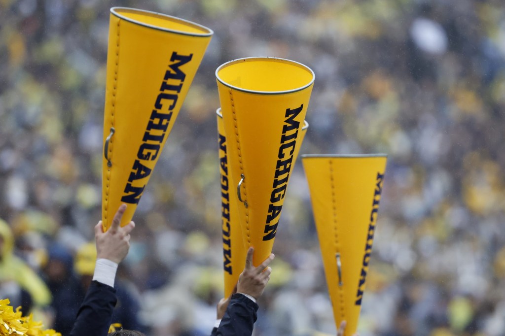  Sep 28, 2024; Ann Arbor, Michigan, USA;  Michigan Wolverines cheerleader hold up megaphone in the first half against the Minnesota Golden Gophers at Michigan Stadium. 