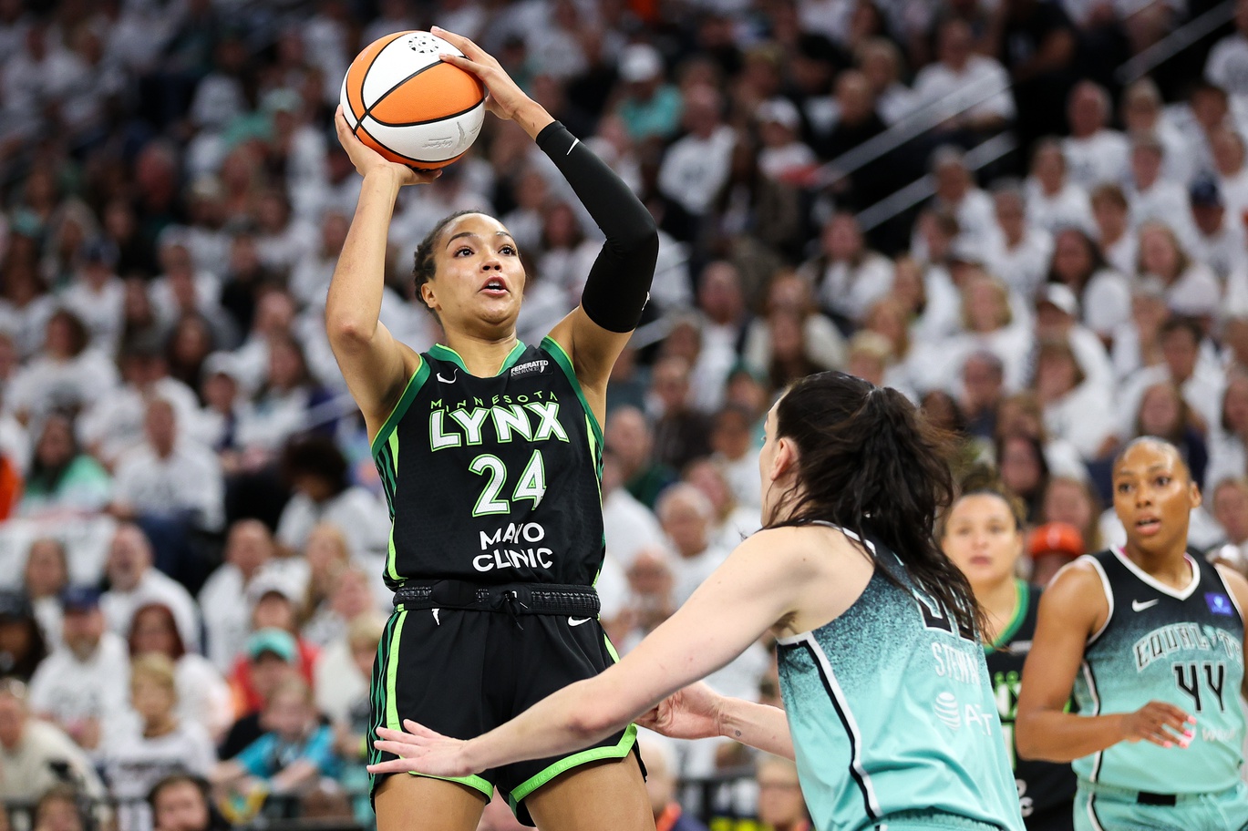 Oct 18, 2024; Minneapolis, Minnesota, USA; Minnesota Lynx forward Napheesa Collier (24) shoots over New York Liberty forward Breanna Stewart (30) during the first half of game four of the 2024 WNBA Finals at Target Center.