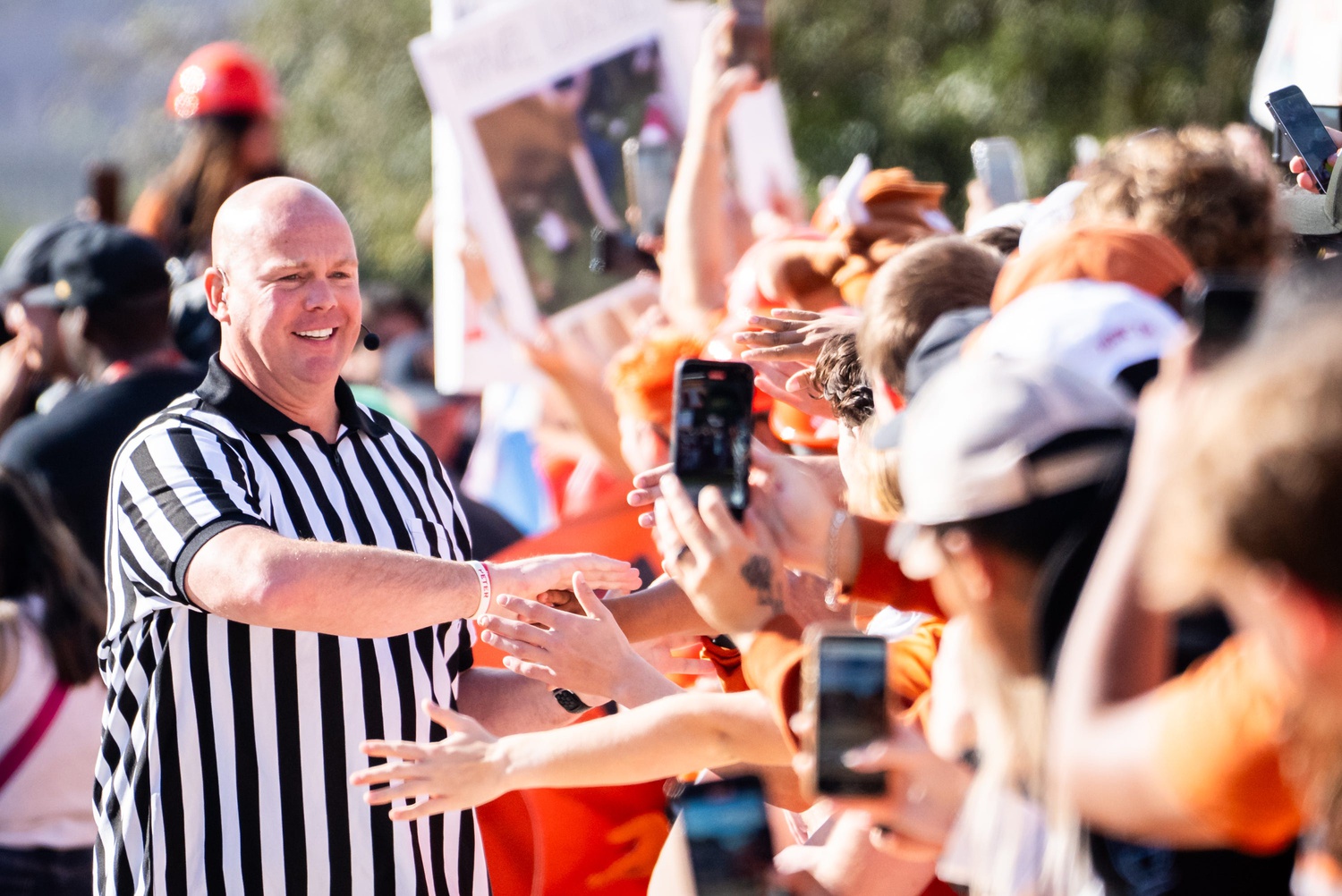 Sports betting Analyst Steve Coughlin gives out high-fives on the set of ESPN's College Game Day at the University of Texas, ahead of the Longhorns' game against the Georgia Bulldogs in Austin, Oct. 19, 2024.