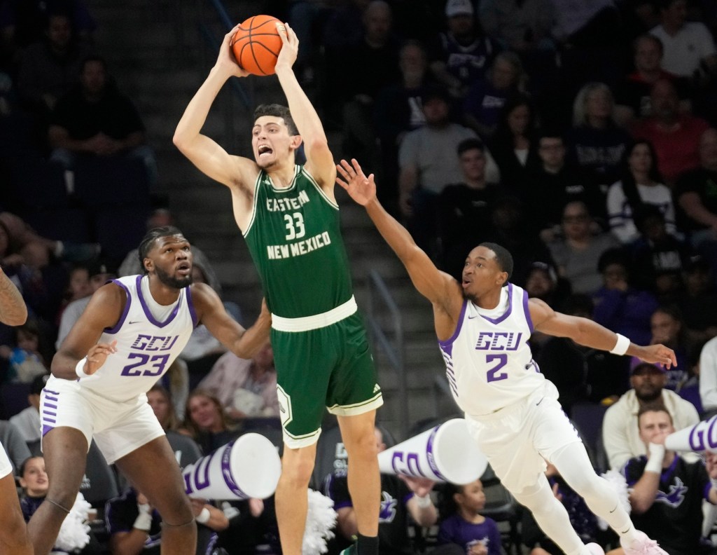 Eastern New Mexico forward Jose Murillo (33) passes the ball between Grand Canyon University forward Sammie Yeanay (23) and guard Makaih Williams (2) during an exhibition game at Global Credit Union Arena in Phoenix on Oct. 29, 2024.