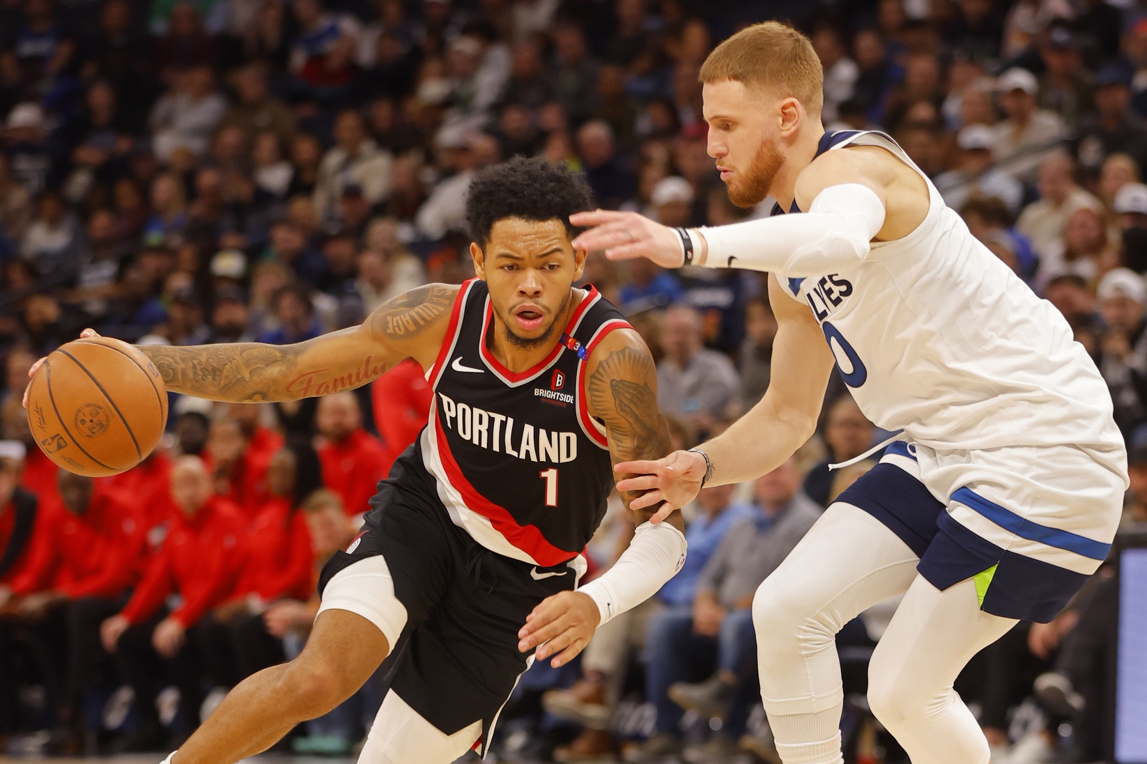 Nov 8, 2024; Minneapolis, Minnesota, USA; Portland Trail Blazers guard Anfernee Simons (1) works around Minnesota Timberwolves guard Donte DiVincenzo (0) in the third quarter at Target Center.