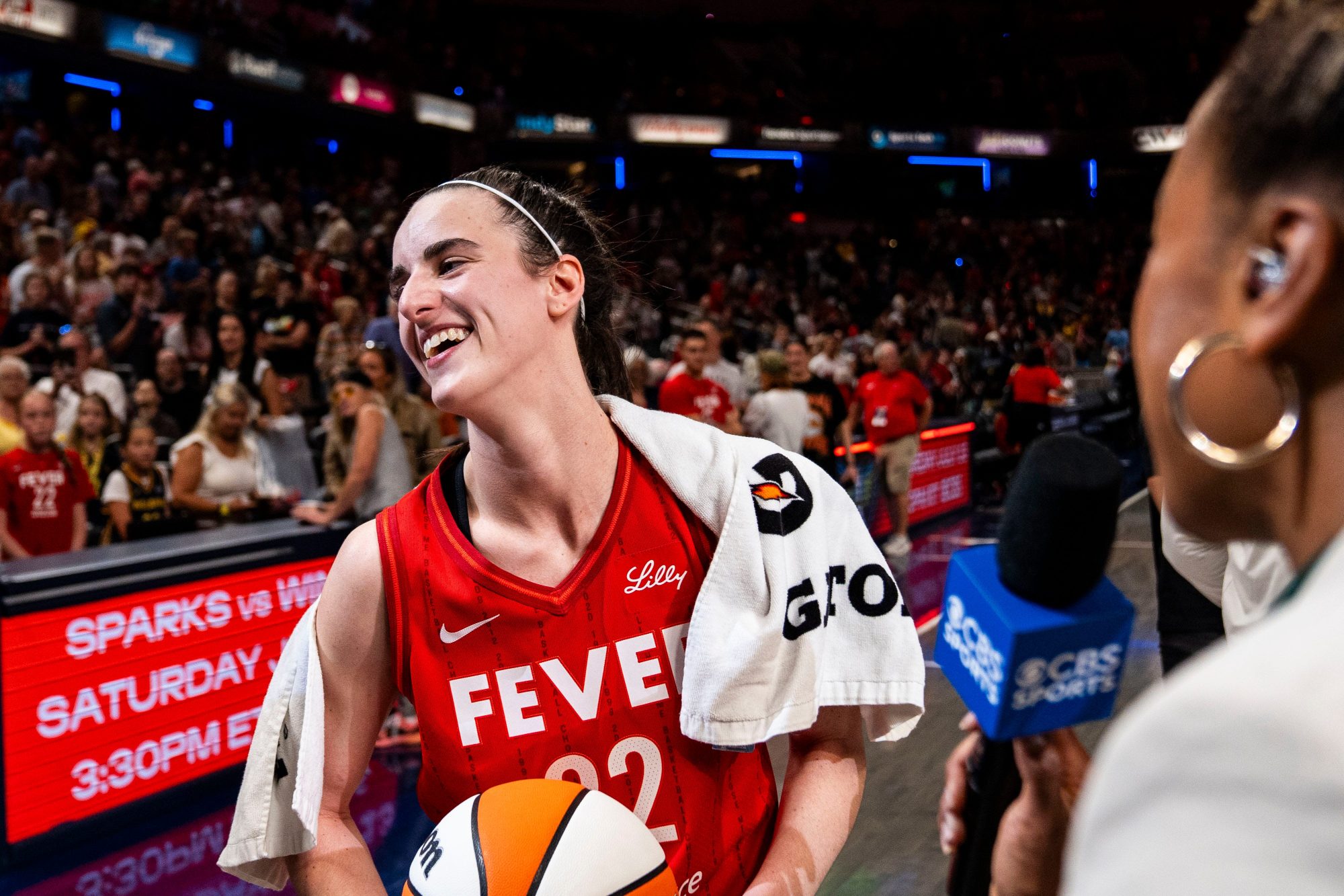 Indiana Fever guard Caitlin Clark (22) smiles in an interview after becoming the first rookie to have a triple-double Saturday, July 6, 2024, during the game at Gainbridge Fieldhouse in Indianapolis.